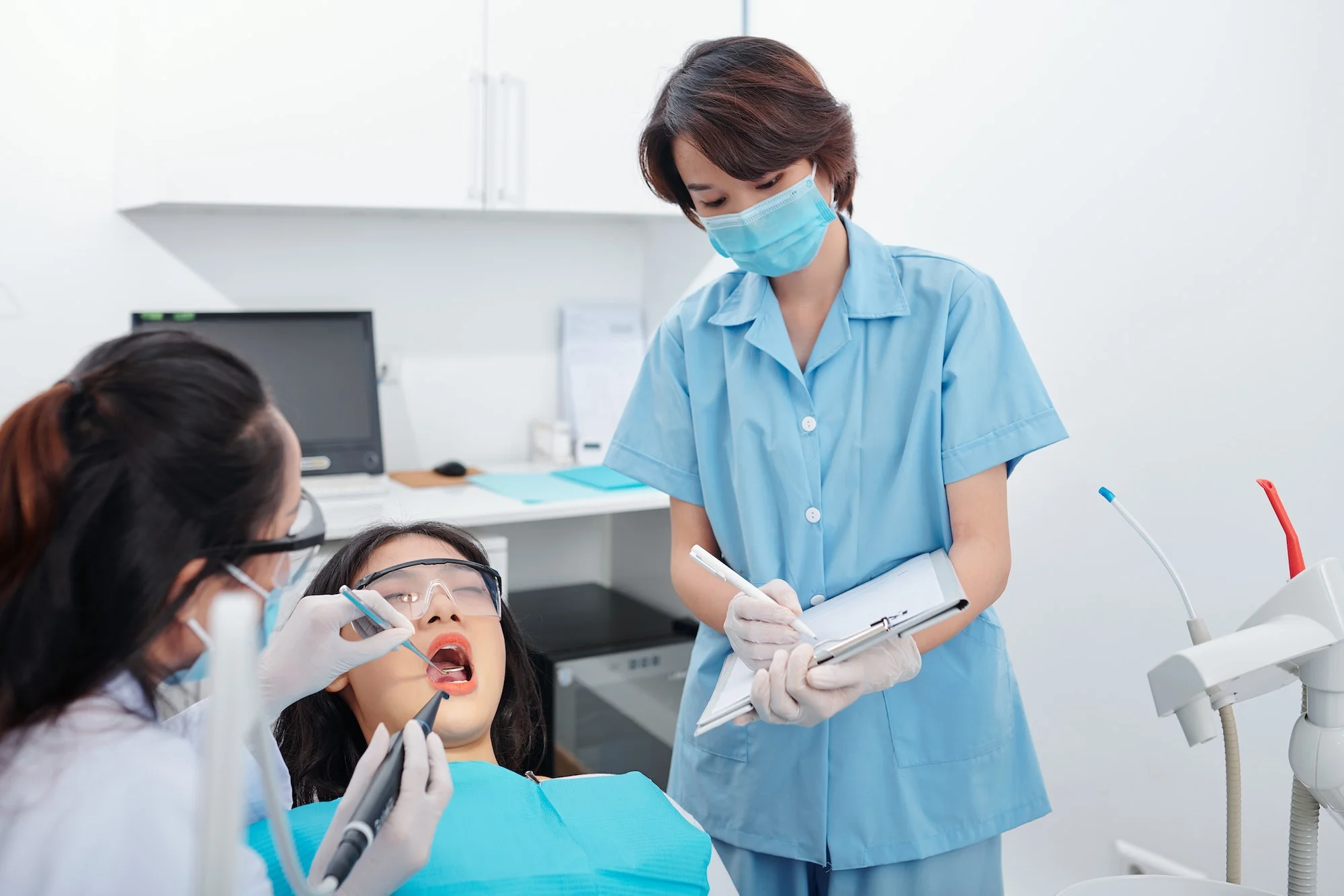 Dentist placing a composite filling on a patient's tooth