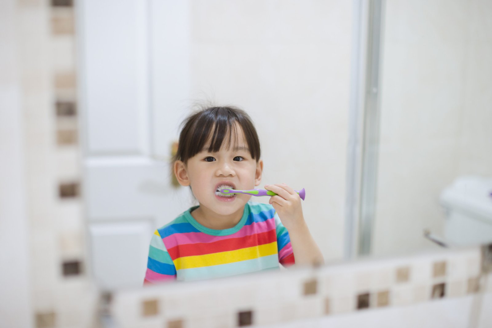 child brushing her teeth